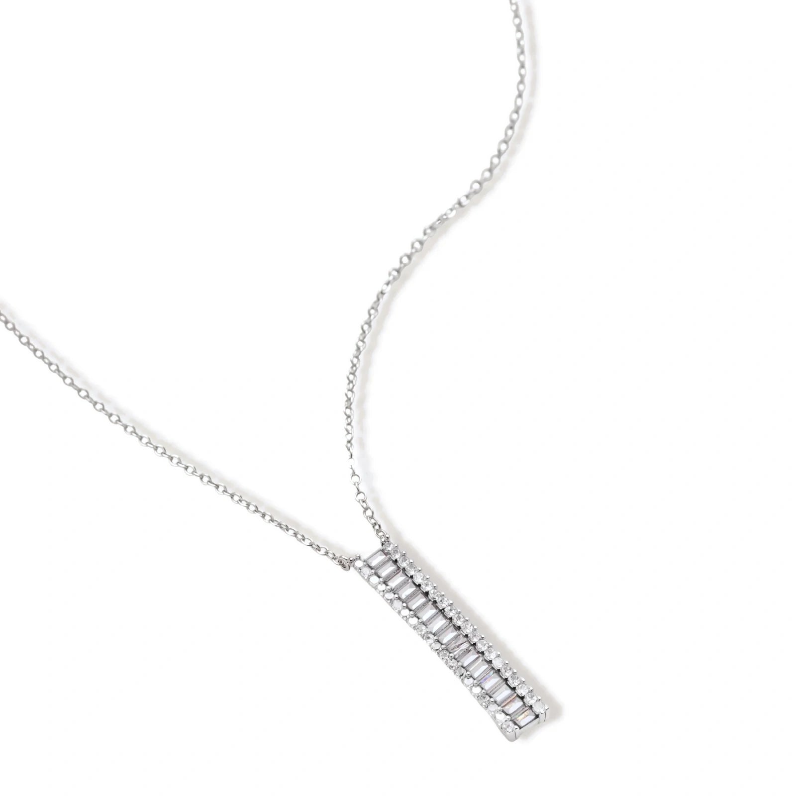 White gold plated necklace with vertical cubic zirconia pendant and matching hoop earrings on neutral background