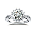 Close-up of sterling silver halo ring with brilliant round moissanite center stone surrounded by smaller accent stones