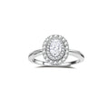 Sterling silver ring with oval moissanite center stone surrounded by double halo of sparkling stones on neutral background.