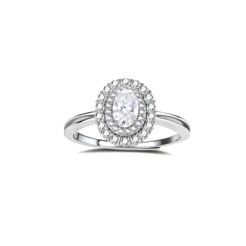Sterling silver ring with oval moissanite center stone surrounded by double halo of sparkling stones on neutral background.