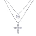 Two delicate sterling silver necklaces with moissanite stones - one solitaire pendant and one cross pendant on white background.