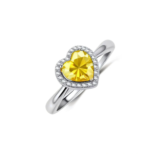 Heart-shaped yellow moissanite ring with diamond halo in sterling silver setting on neutral background
