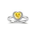 Heart-shaped yellow moissanite ring with diamond halo in sterling silver setting on neutral background