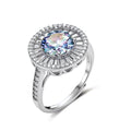 Close-up of sterling silver halo ring with round rainbow moissanite center stone surrounded by baguette-cut stones
