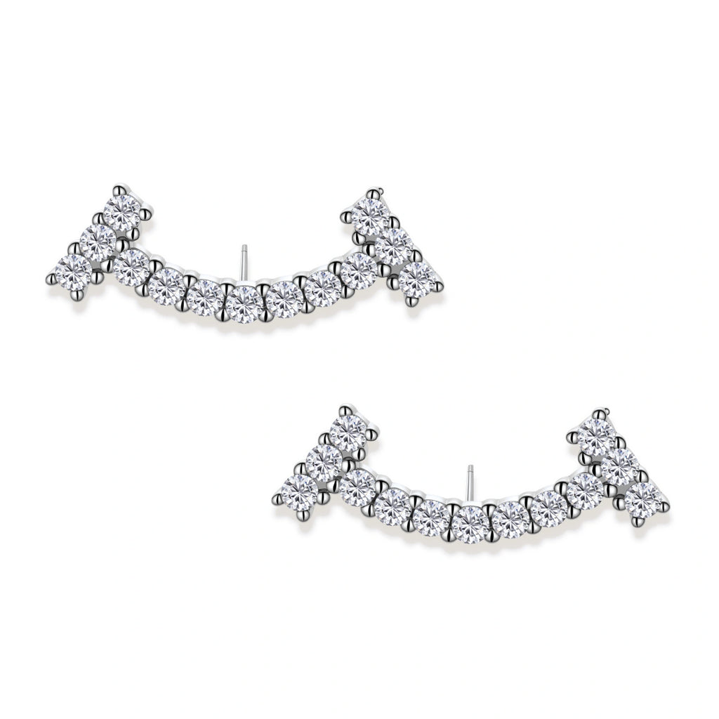 Curved sterling silver ear climbers with moissanite stones arranged in elegant arc shape on white background