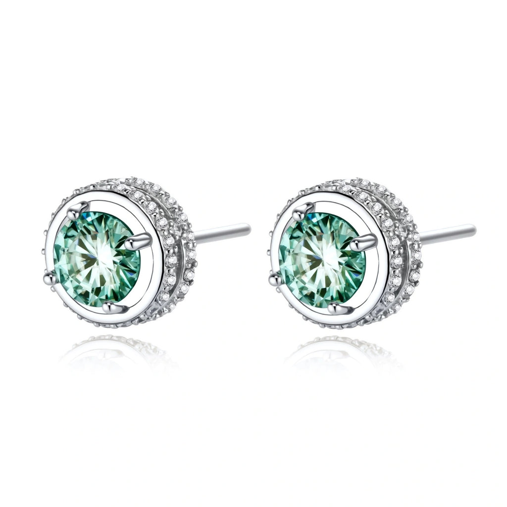 Round green moissanite stud earrings in sterling silver halo settings with brilliant sparkle on white background.