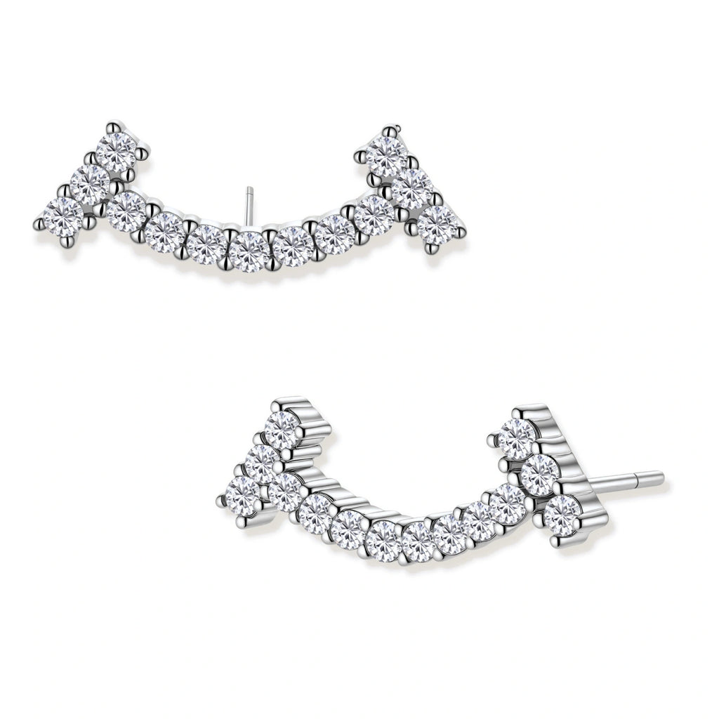 Curved sterling silver ear climbers with moissanite stones arranged in elegant arc shape on white background