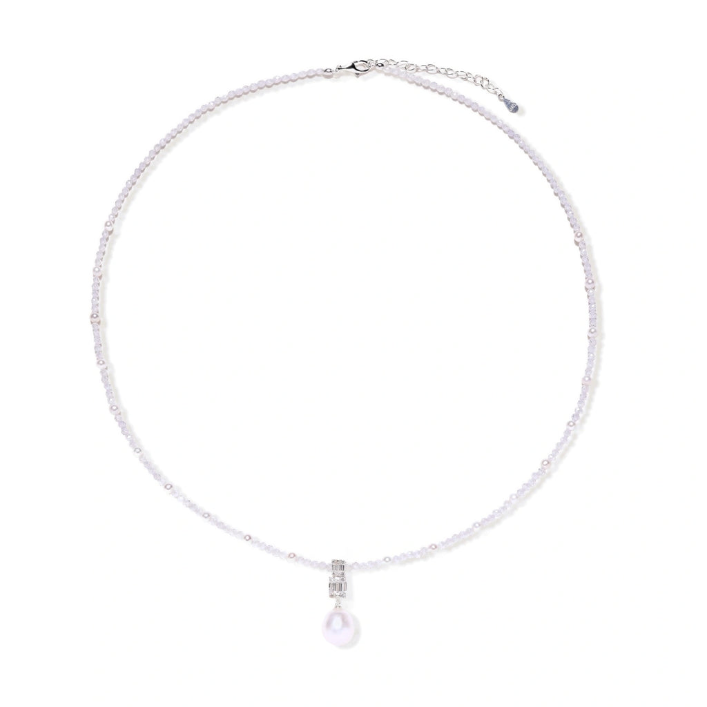 Dainty necklace with lavender crystal beads, freshwater pearls, geometric pendant, and large pearl drop on white background.