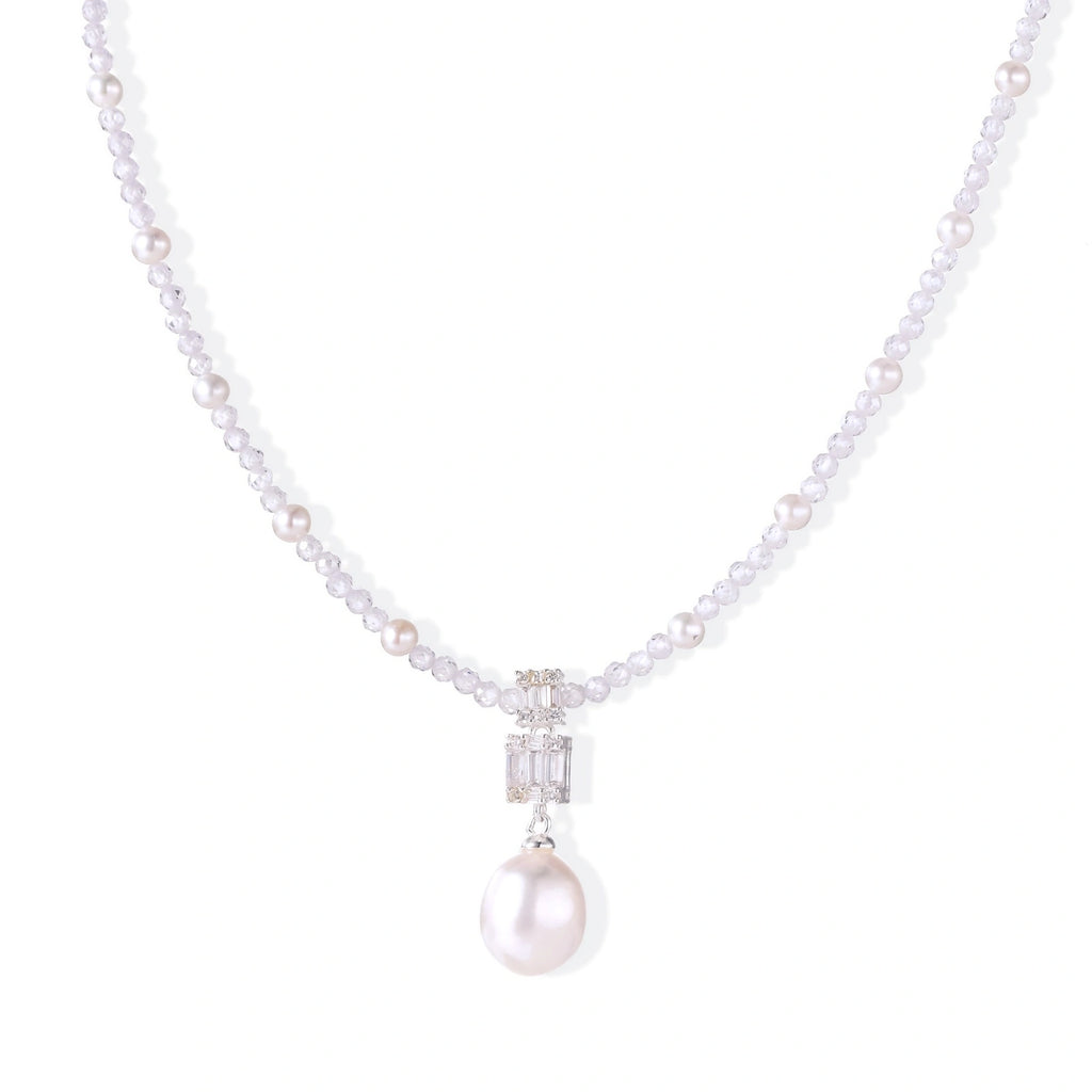 Dainty necklace with lavender crystal beads, freshwater pearls, geometric pendant, and large pearl drop on white background.