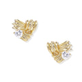 Pair of sculptural gold-plated wing stud earrings with zirconia stones on cream background, showing dimensional feather design