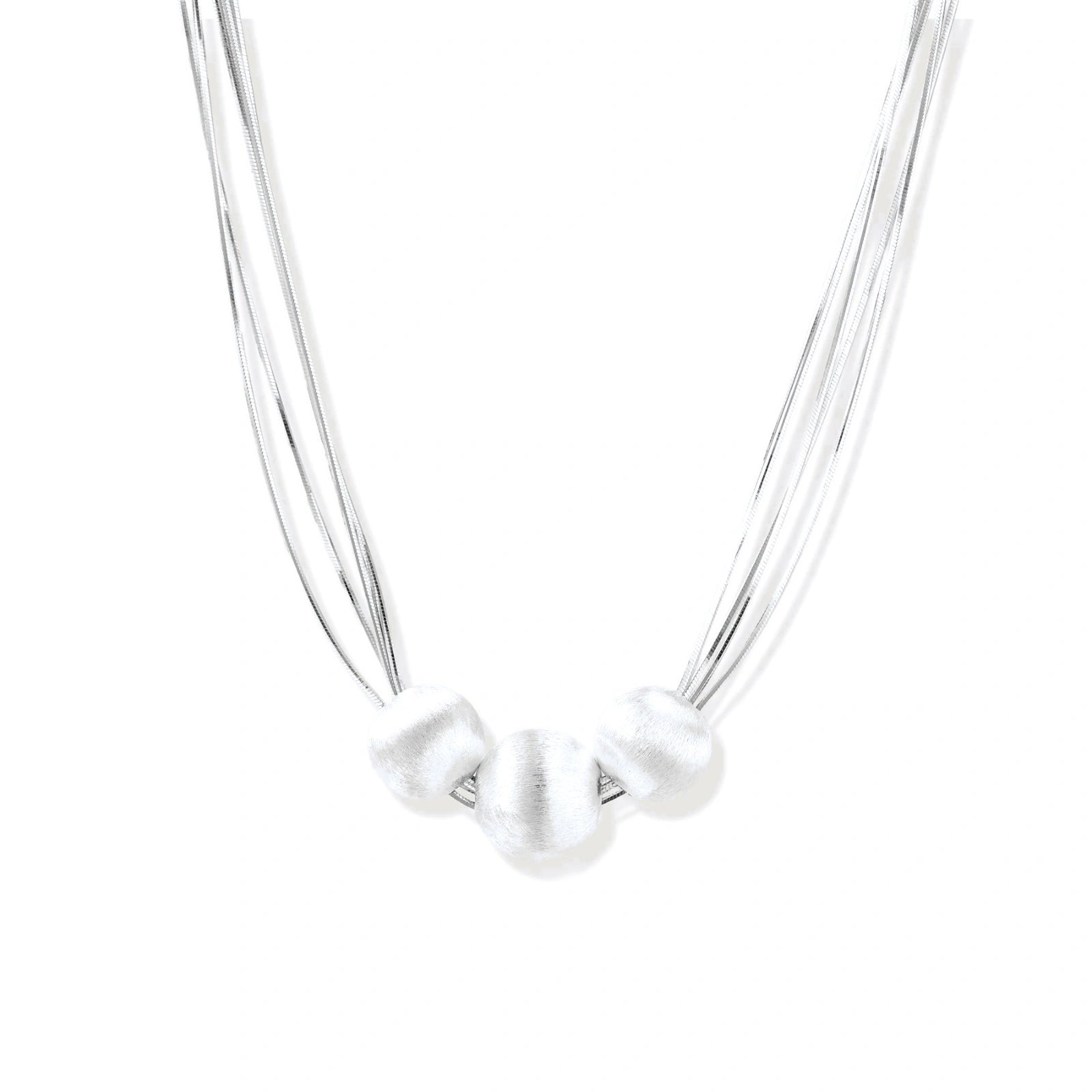 Sterling silver multi-strand necklace with three brushed round beads on cream background