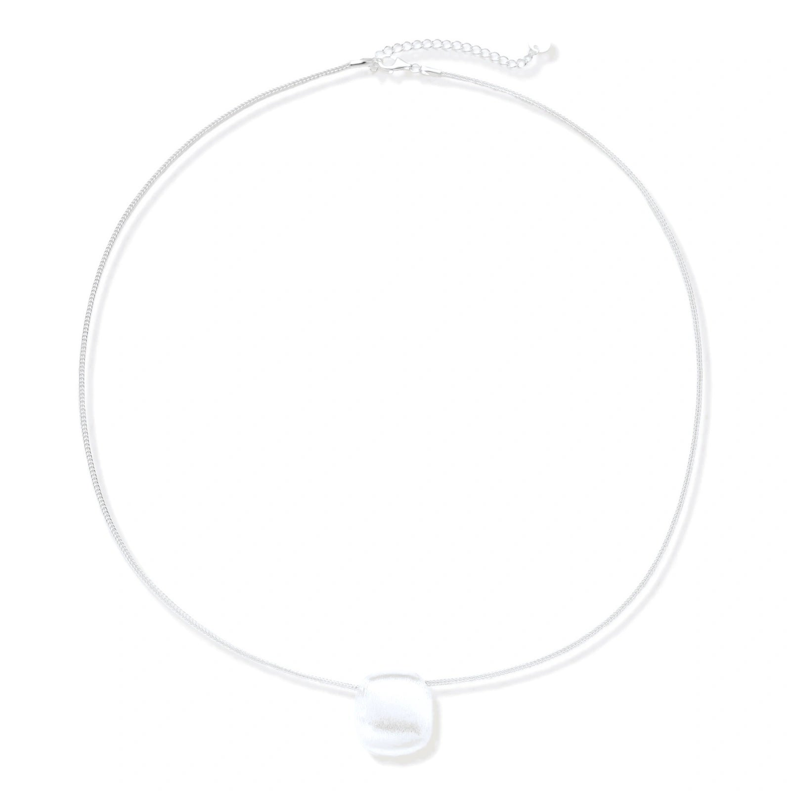 Minimalist brushed sterling silver dome pendant on delicate chain against cream background, showing matte textured finish