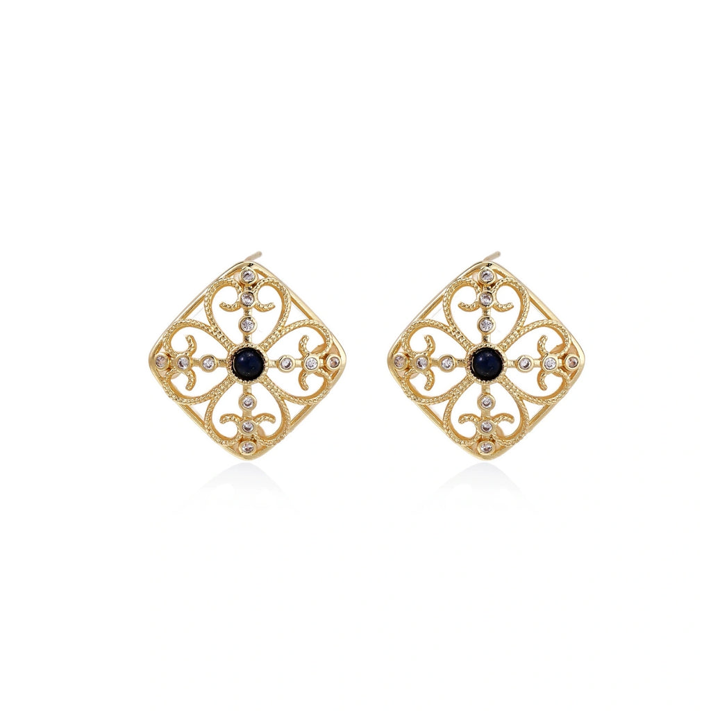 Gold filigree stud earrings with navy lapis lazuli center stone and mother-of-pearl accents in ornate quatrefoil design