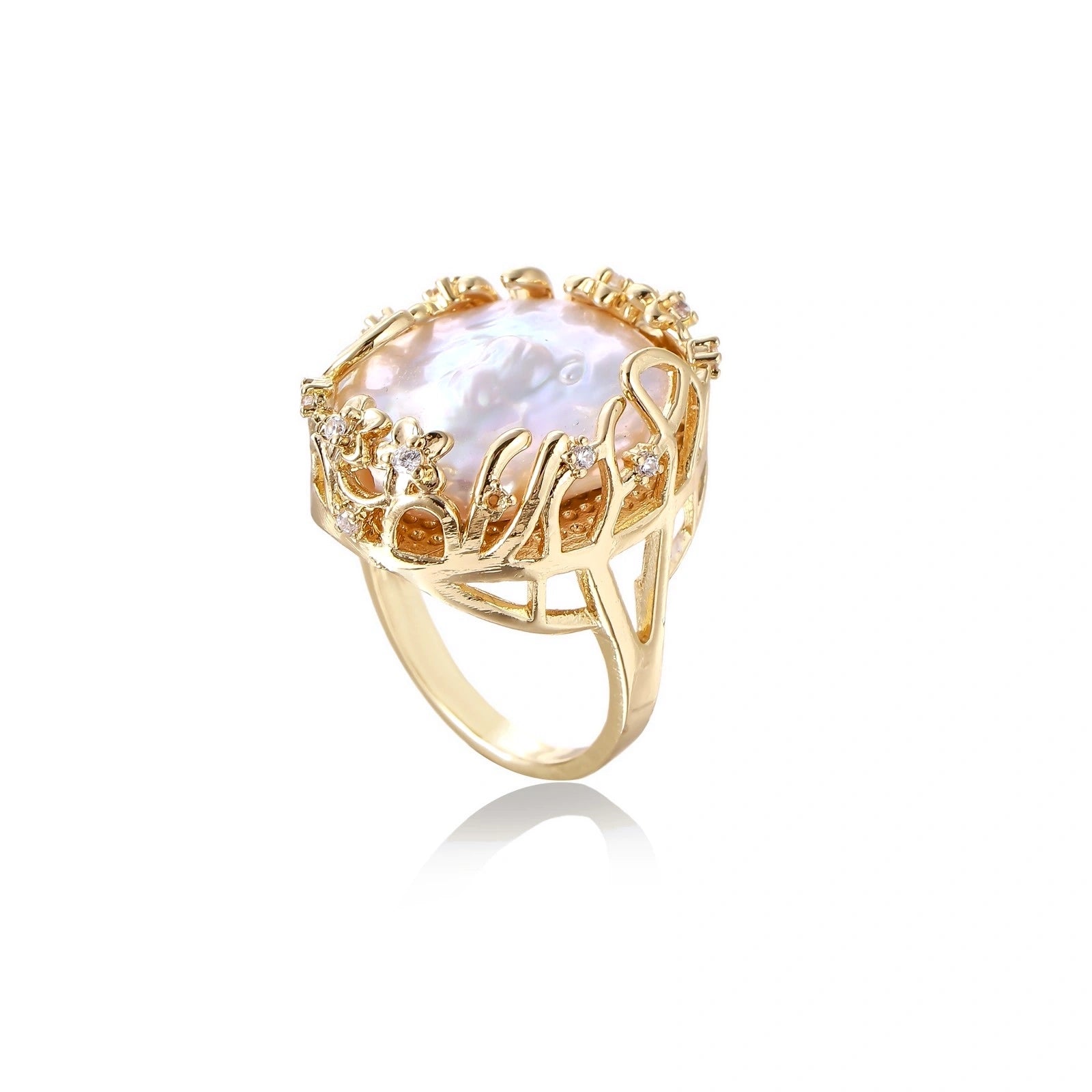 Gold filigree crown ring cradling an iridescent baroque freshwater pearl with crystal accents on white background