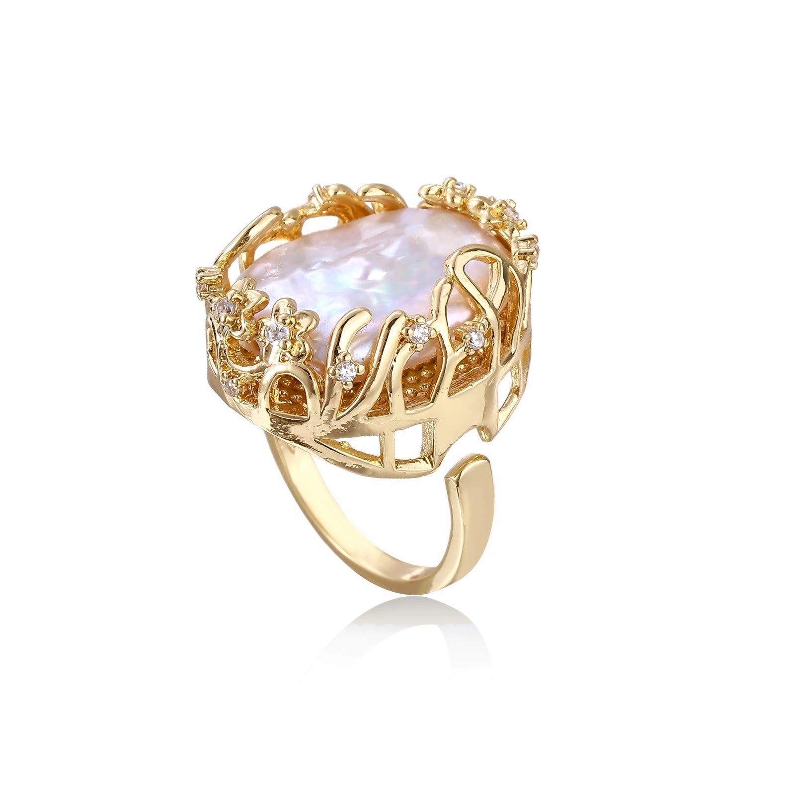 Gold filigree crown ring cradling an iridescent baroque freshwater pearl with crystal accents on white background