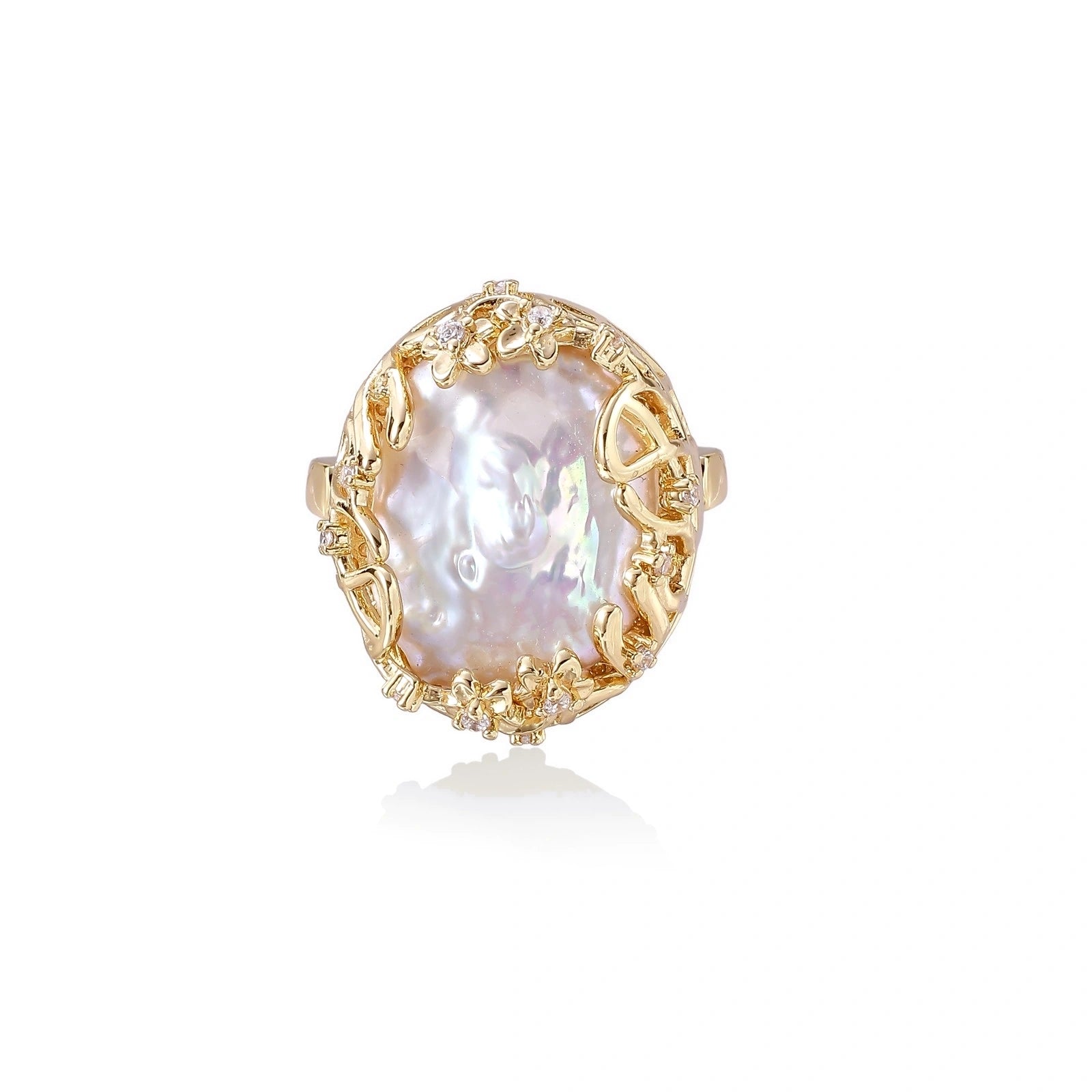 Gold filigree crown ring cradling an iridescent baroque freshwater pearl with crystal accents on white background