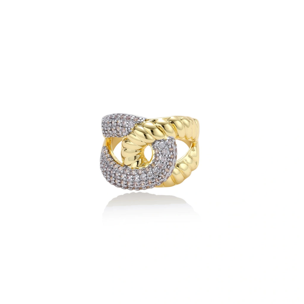 Chunky gold-plated chain-link ring with curved segments and sparkling zirconia crystals on neutral background