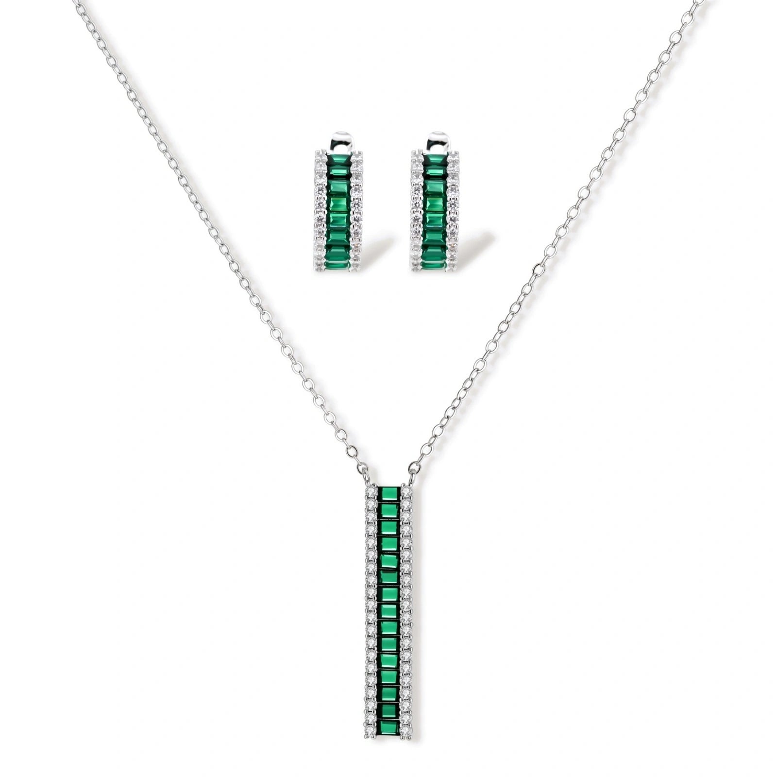 White gold plated jewelry set with emerald green rectangular stones and clear crystals in geometric rows on white background.