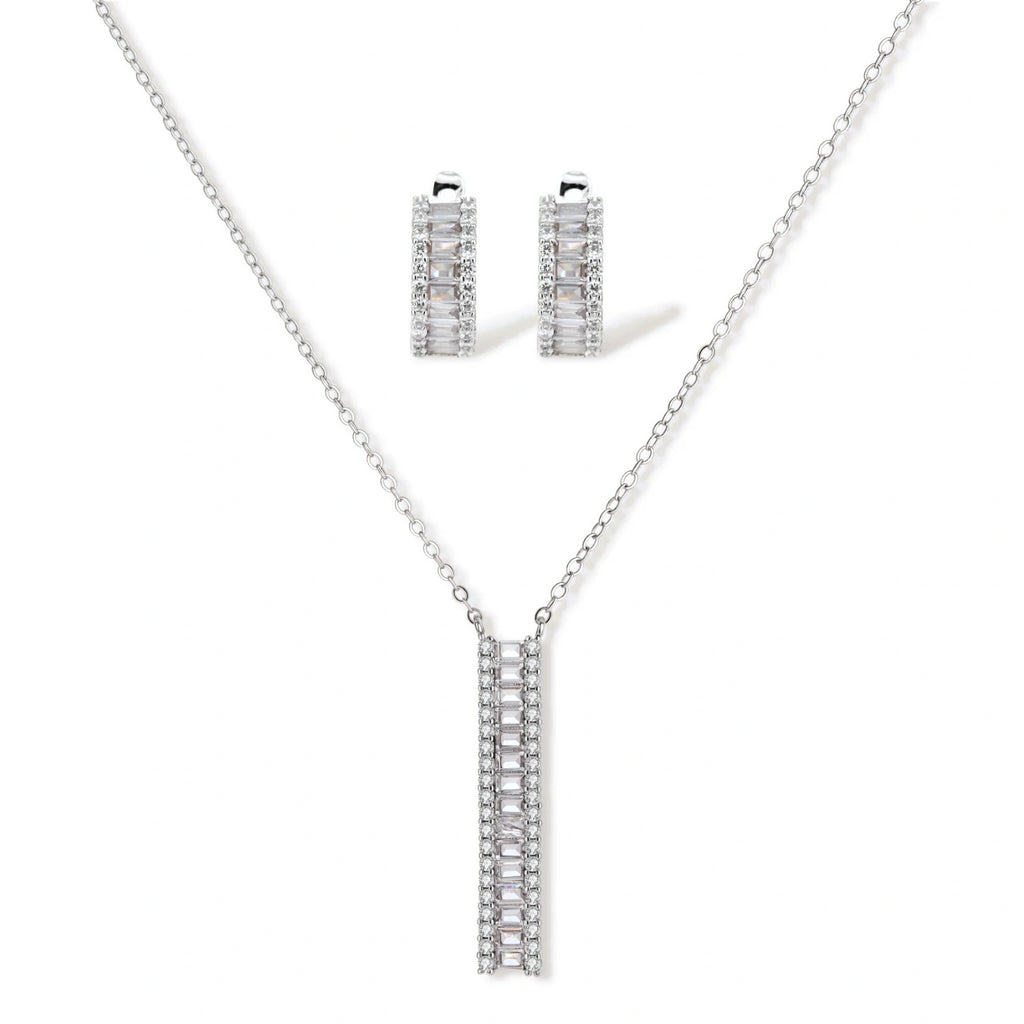 White gold plated necklace with vertical cubic zirconia pendant and matching hoop earrings on neutral background