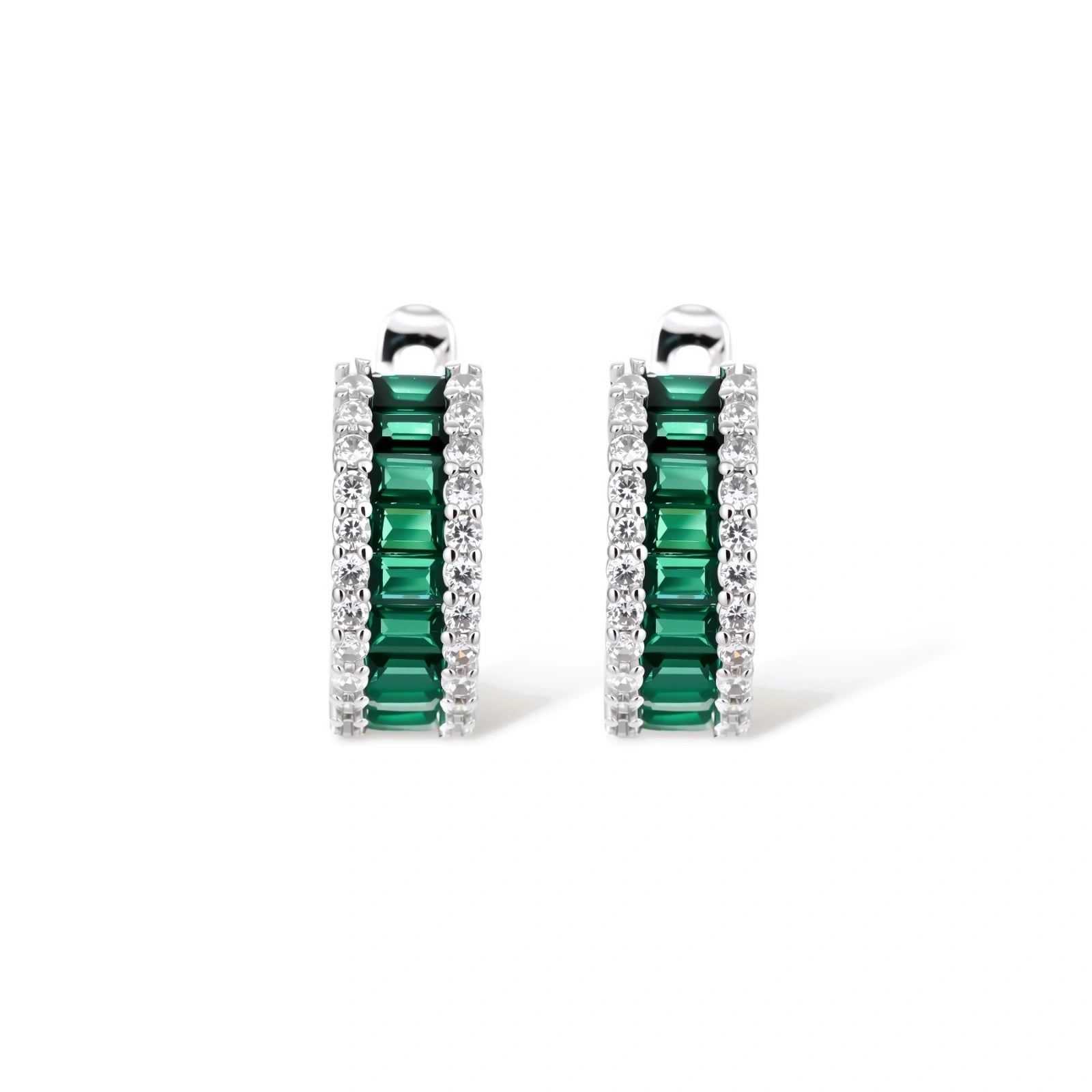 White gold plated jewelry set with emerald green rectangular stones and clear crystals in geometric rows on white background.