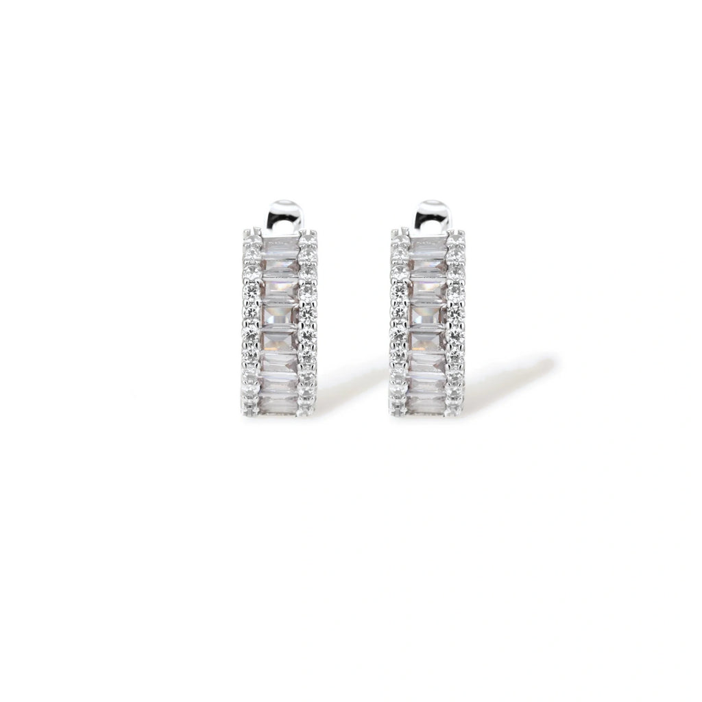 White gold plated necklace with vertical cubic zirconia pendant and matching hoop earrings on neutral background